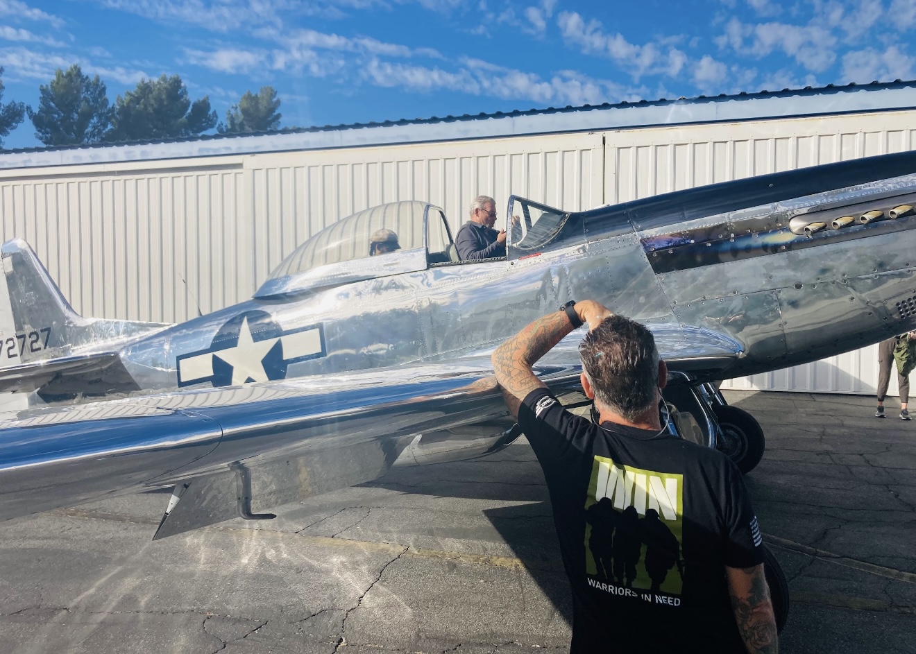 P-51 ride winner at a Warriors In Need event supporting veterans, veteran transition, and aviation-inspired opportunities.